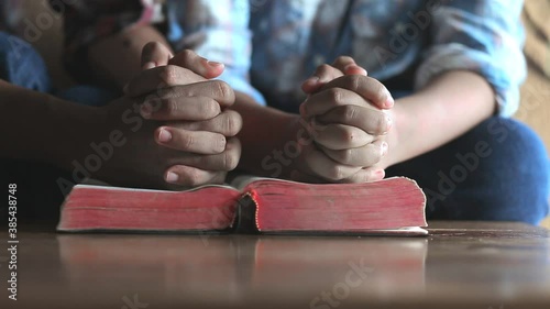 Close up hands praying on the bible, Home church father and son, Religion concept. photo