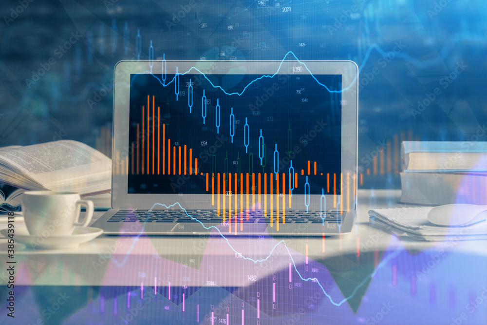 Forex market graph hologram and personal computer on background. Multi exposure. Concept of investment. Forex market graph hologram and personal computer on background. Multi exposure. Concept of investment.