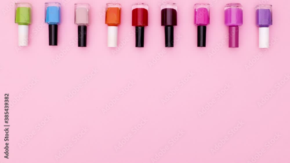 Black nail polish bottles change color on top of pink theme. Stop motion Black nail polish bottles change color on top of pink theme. Stop motion