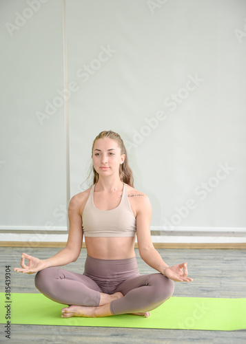 Strength posture of healthy young Caucasian women wearing sportswear doing Yoga workout at home.