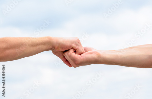 Helping hand outstretched. Friendly handshake, friends greeting, teamwork, friendship. Rescue, helping gesture or hands. Two hands, helping arm of a friend, teamwork © Yevhen