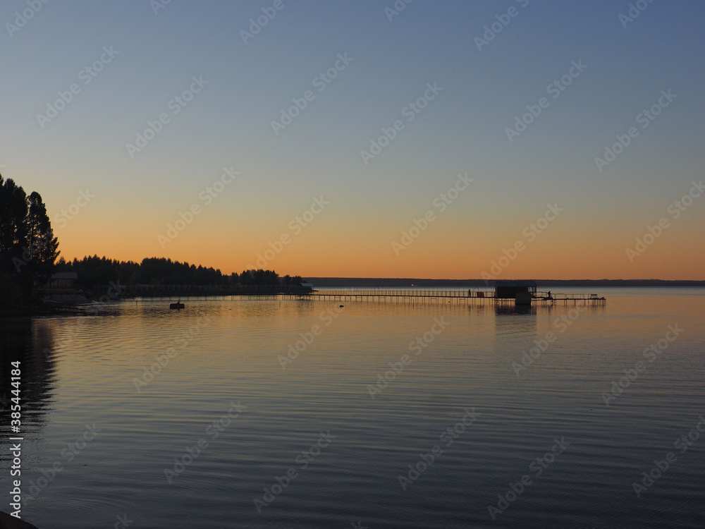 Sunset, summer, beautiful sky. Pier on the big Kama river. Ural, Russia, Perm Territory, Elovo.