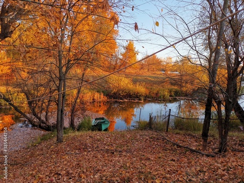 Autumn view with a lake. Autumn leaves of the earth. Autumn landscape of a forest lake. Autumn leaves