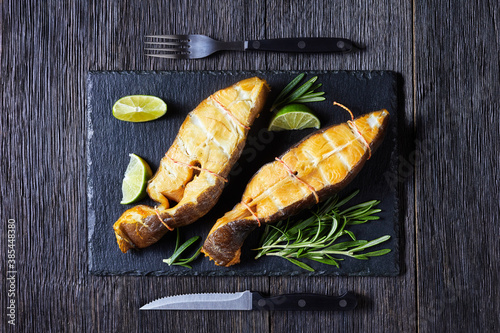 Fotografie Traditional smoked halibut fish steaks with lime