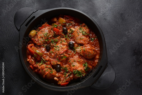 Chicken cacciatore with bell peppers, tomatoes, black olives. Italian food photo