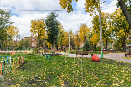 In the courtyard of stalinka building. Orange and green trees, Ukraine, Kharkov