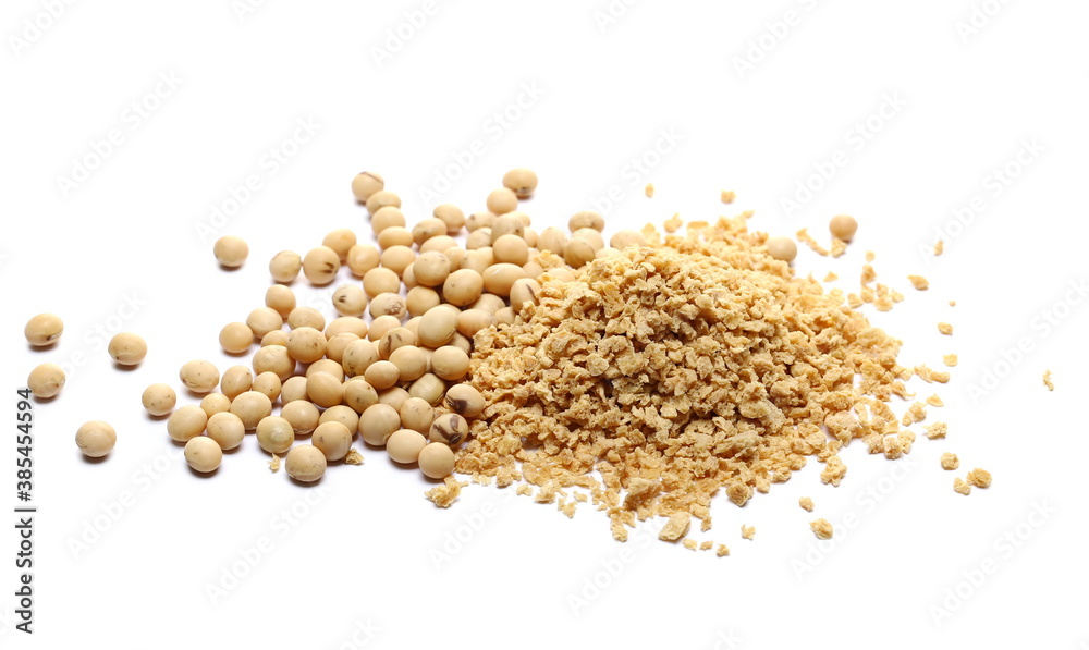 Organic raw soybeans and soy flakes pile isolated on white background Organic raw soybeans and soy flakes pile isolated on white background