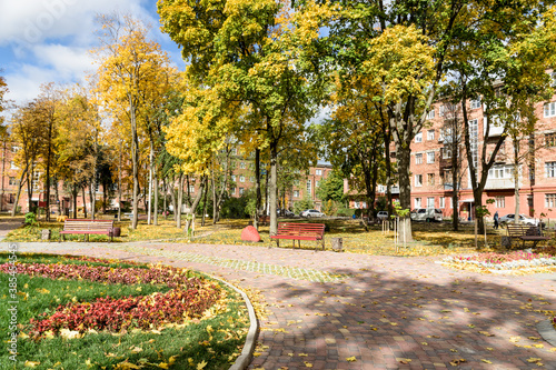 In the courtyard of stalinka building. Orange and green trees, Ukraine, Kharkov