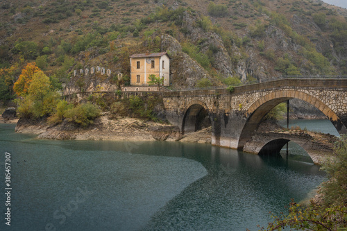 View of bridge and Eremo di San Domenico (Prato Cardoso) on the lake in Abruzzo, Italy photo