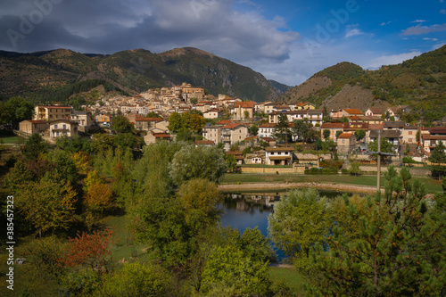 Scenic view of the sunny town of Villalago on the shores of Lake Pio in pre-storm weather in Abruzzo, Italy photo