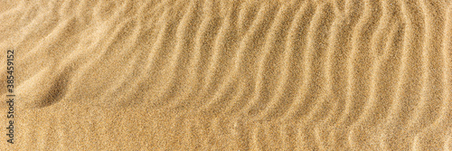 Closeup sand on the beach formed by wind. Panoramic image