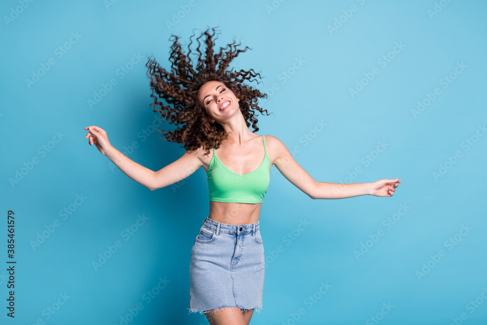 Photo of shiny funky festive bright lady model spinning curly hair whirl wind round wheel shape adventures camp center advert wear green top denim skirt isolated pastel blue color background Photo of shiny funky festive bright lady model spinning curly hair whirl wind round wheel shape adventures camp center advert wear green top denim skirt isolated pastel blue color background