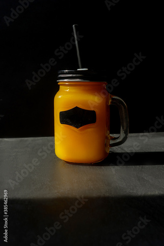 Orange Halloween cocktail and black background.