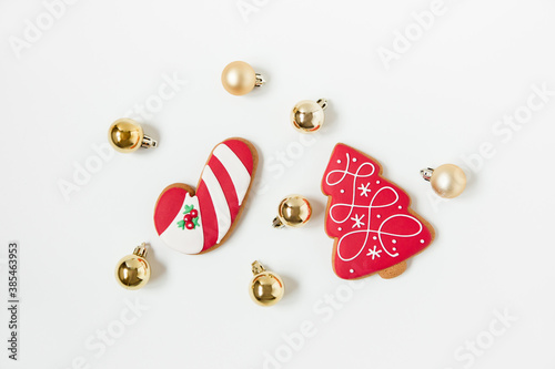 new year and christmas gingerbread cookies and christmas toys. tree shaped. top view. white background. minimalist style. © Kolomiiets Viktoriia