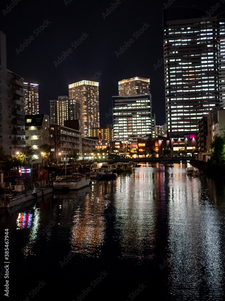 The night view of the buildings and the river illuminated by it