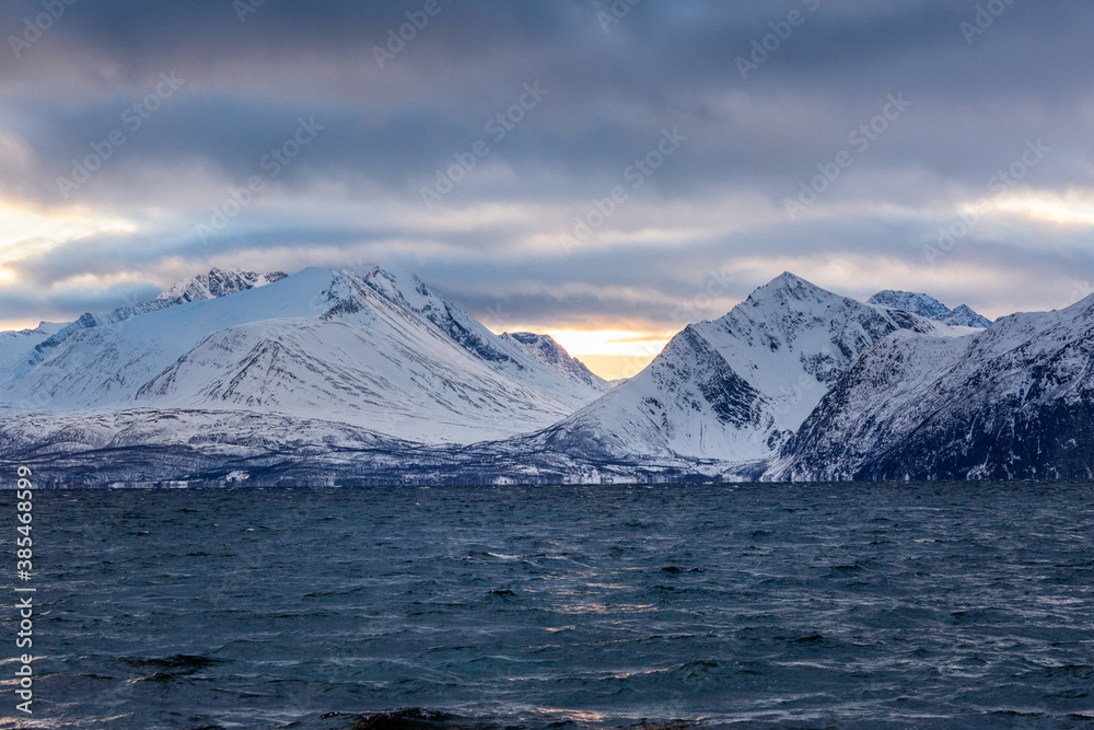Beautiful winter landscape with mountains, sea and sunlight