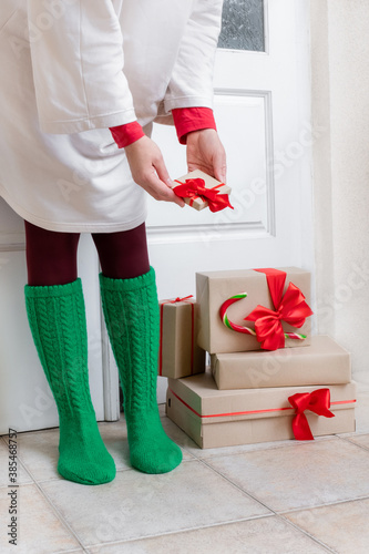 woman gifts package box door home green sock red Christmas new year delivery