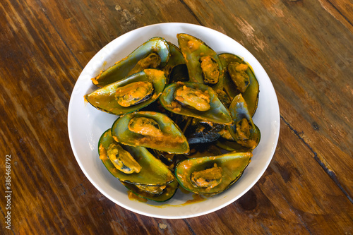 Top view of Mussels in Salted Egg sauce. A variant of a popular snack or meal in the Philippines, locally known as Tahong. photo