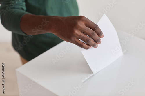 Close-up of African man holding ballot and giving his voice during voting
