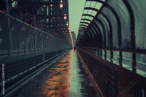 Walking along a bridge at night