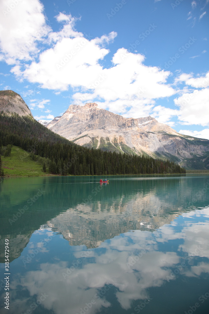 View of Bow lake with people Canoeing on lake during summer in Banff National Park, Canadian Rockies, Alberta, Canada.
