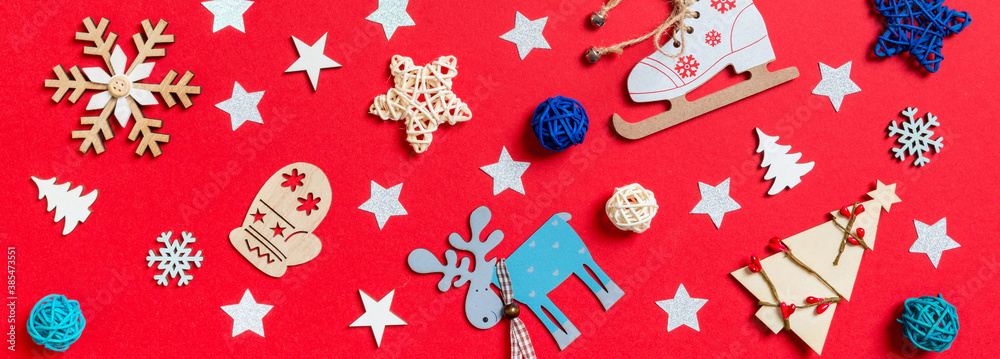 Banner top view of holiday toys and decorations on red Christmas background. New Year time concept Banner top view of holiday toys and decorations on red Christmas background. New Year time concept