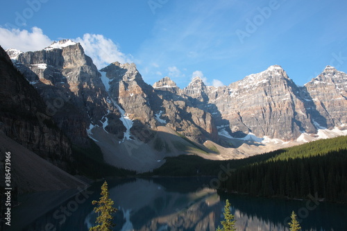 View of The Moraine Lake with snow covered mountain peaks during summer in Banff National Park, Canadian Rockies, Alberta, Canada.