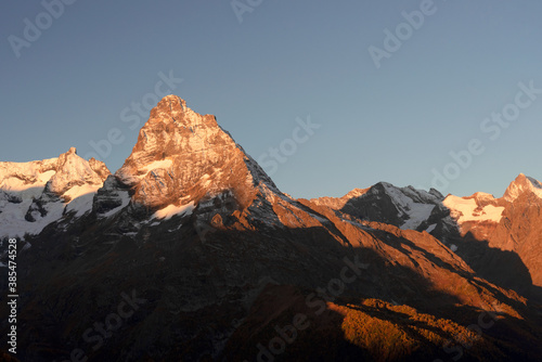 top of Mount Belalakaya in Dombai at sunrise with blue sky. © Ambartsumian