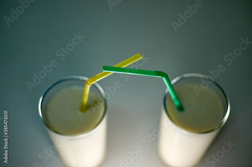 Milkshakes with straws on a white background. Concise and delicious.