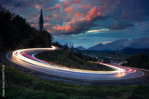 Long exposure - Lights on the asphalt, at night on a mountain road