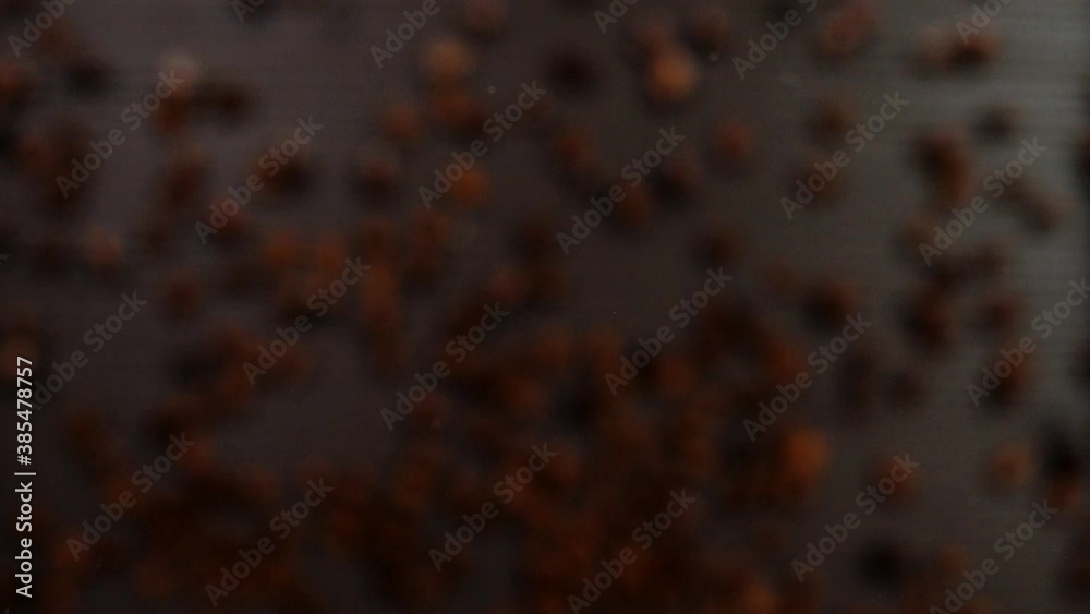 Beautiful aromatic coffee beans on a black background. Super slow motion. Macro Beautiful aromatic coffee beans on a black background. Super slow motion. Macro
