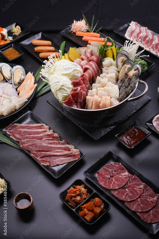 Shabu Shabu or Sukiyaki, a popular dish of pork, beef, shrimp, squid, seafood and fresh vegetables. Placed on a table with a boiling pot boiling. Shabu Shabu or Sukiyaki, a popular dish of pork, beef, shrimp, squid, seafood and fresh vegetables. Placed on a table with a boiling pot boiling.