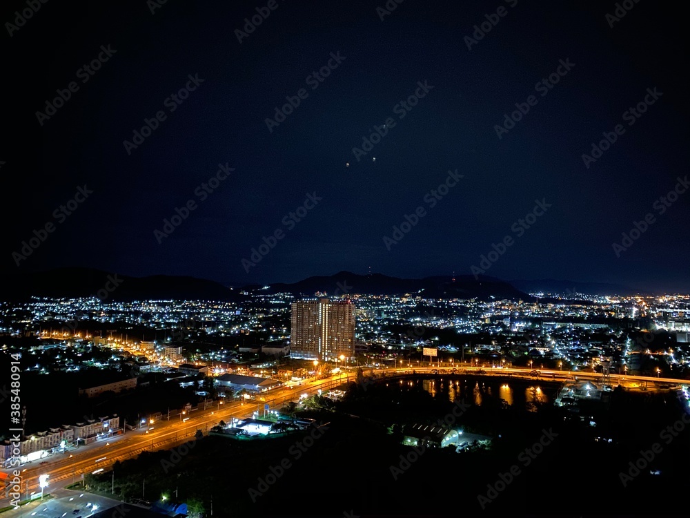 Panoramic wide scene in dark night with the colourful light of downtown