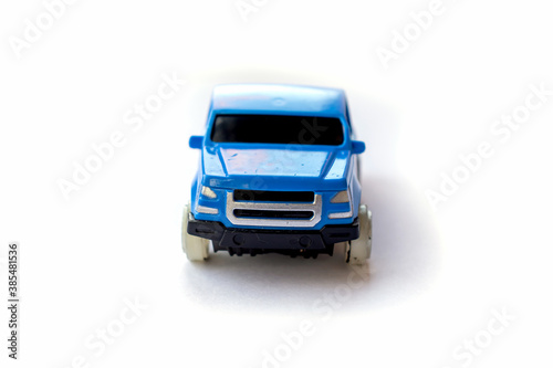 Children’s toy little blue car on a white background.