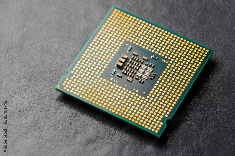 The microprocessor processor of the CPU of a computer or laptop lies on a dark matte surface. Close-up. Electronic and computing equipment. Macro The microprocessor processor of the CPU of a computer or laptop lies on a dark matte surface. Close-up. Electronic and computing equipment. Macro