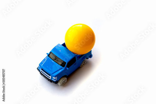 Yellow ball in a blue car. Kids toys. Isolated item on a white background. Top view