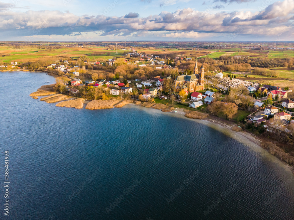 Aerial view of Rajgrodzkie Lake and church in Rajgrod, autumn time, Poland