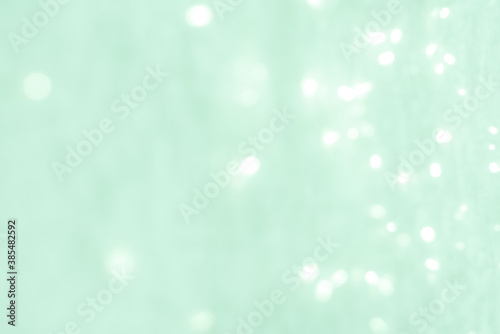 abstract background. light celadon green blurry lights. bokeh. texture. christmas, holiday