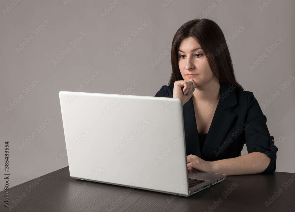 Young woman in blue with laptop. Young woman in blue with laptop.