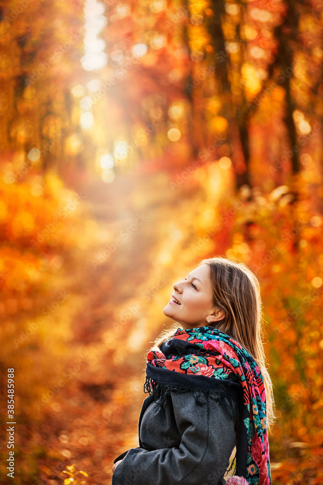Portrait of beautiful smiling woman posing in autumn forest with cup of tea Portrait of beautiful smiling woman posing in autumn forest with cup of tea