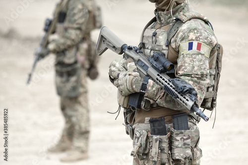 Fotografie Soldiers with assault rifle and flag of France on military uniform