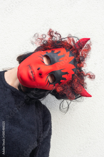 Fototapeta Naklejka Na Ścianę i Meble -  women with red devil mask, wear red horns