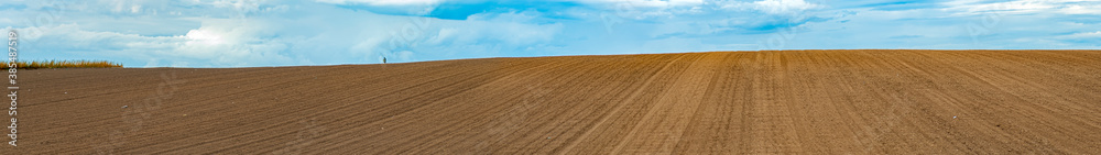 Landscape with agricultural land, in slope, recently plowed and prepared for the crop