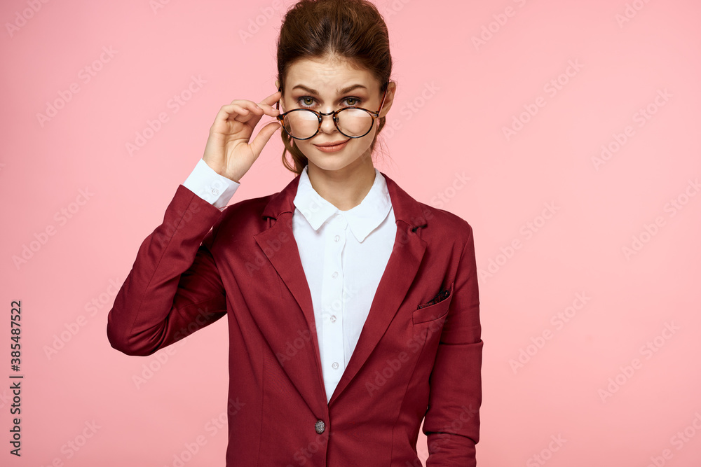 Elegant woman in red jacket glasses office manager pink background