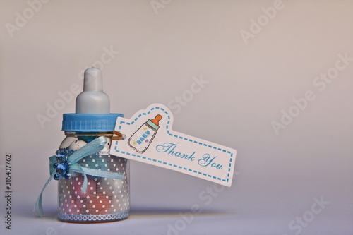 Bottle with sweets and thank you card  as gift for baby shower