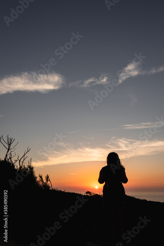 Silhouette of a woman watching the sunset. Golden Hour.