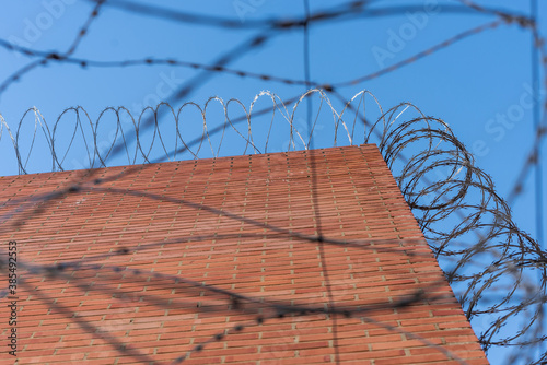 Generic prison wall with concertinas and barbed wire