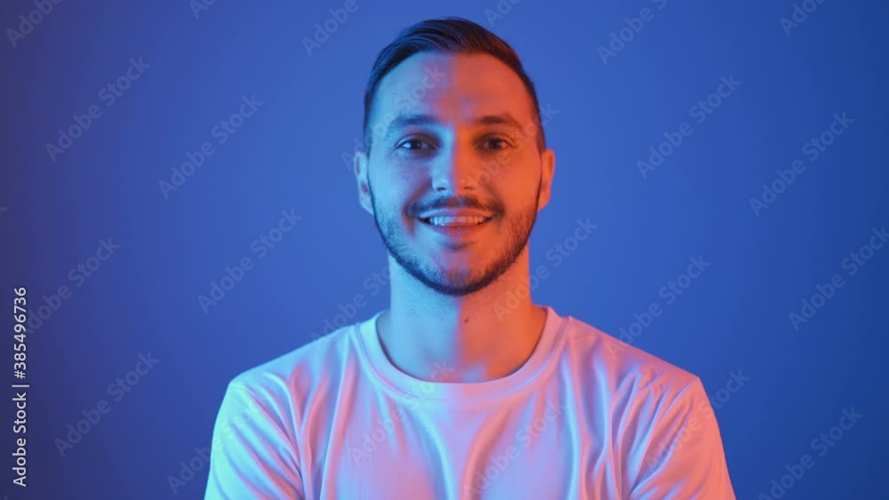 portrait of smiling football fan with red and blue lights portrait of smiling football fan with red and blue lights