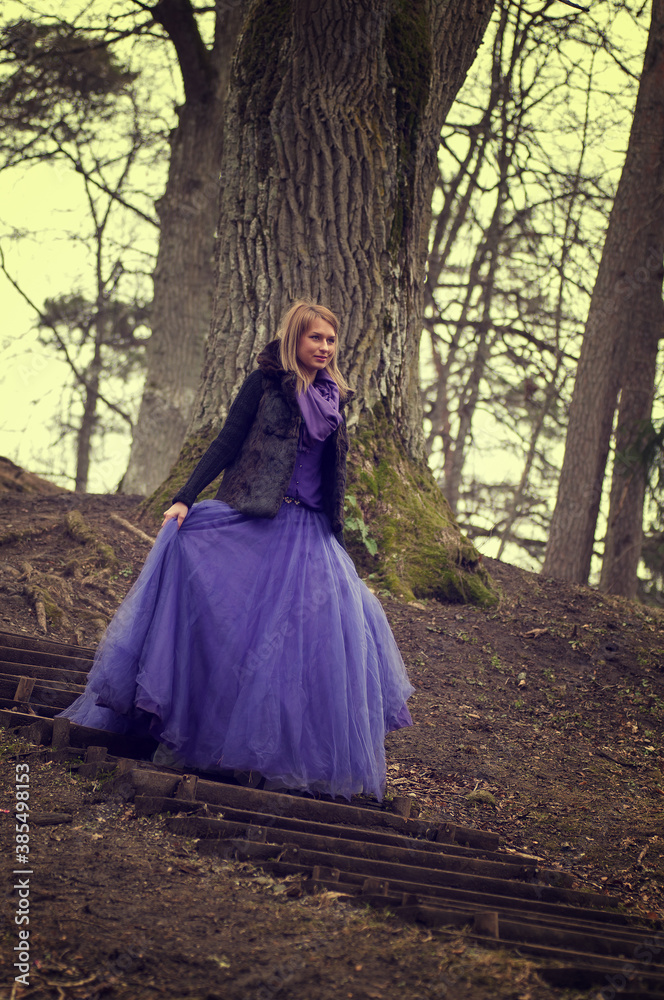 woman in forest with violet dress woman in forest with violet dress