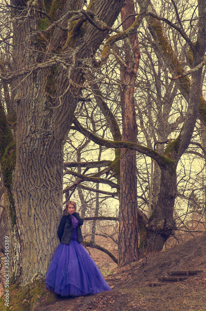 woman in forest with violet dress